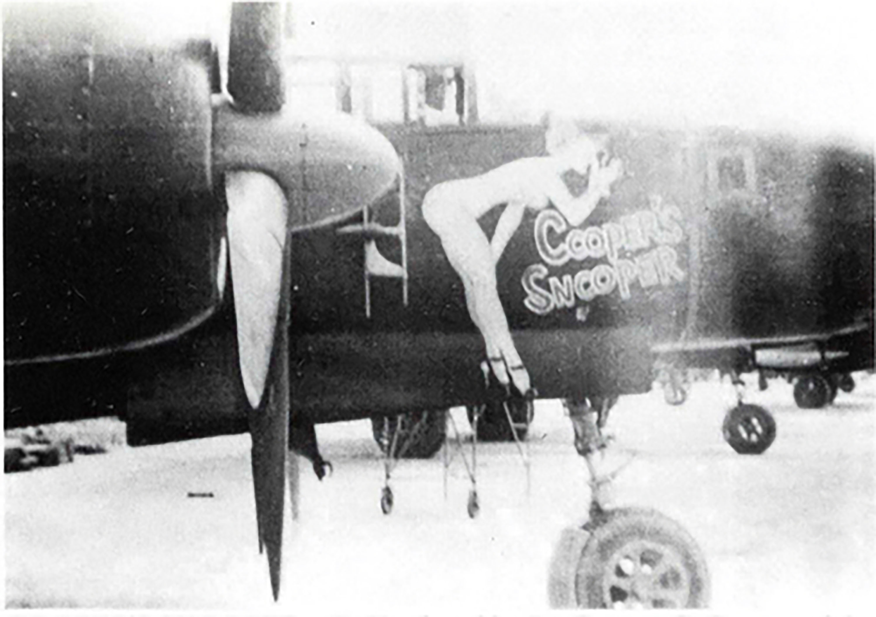 A work of nose art on an American P-61 features a seemingly nude woman  peeping